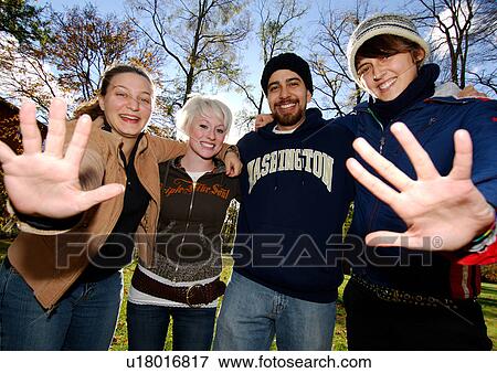 Front view of four friends posing for the camera. View Large Photo Image Stock Photo - Front view of four friends posing for the camera.. Fotosearch
