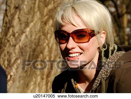 Portrait of a blonde woman wearing sunglasses. View Large Photo Image Stock Photography - Portrait of a blonde woman wearing sunglasses.. Fotosearch