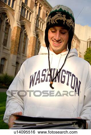 Portrait of a cheerful young man holding his folder. View Large Photo Image Stock Photograph - Portrait of a cheerful young man holding his folder.. Fotosearch