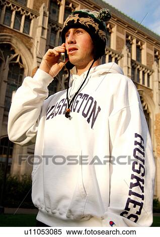 Portrait of a young man conversing on his cell phone. View Large Photo Image Stock Photography - Portrait of a young man conversing on his cell phone.. Fotosearch