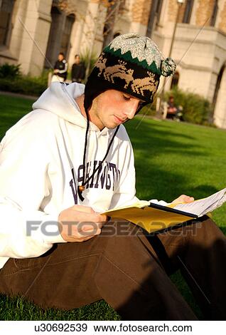 Portrait of a young man engrossed in a book. View Large Photo Image Stock Photo - Portrait of a young man engrossed in a book.. Fotosearch