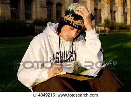 Portrait of a young man engrossed in a book. View Large Photo Image Stock Photograph - Portrait of a young man engrossed in a book.. Fotosearch