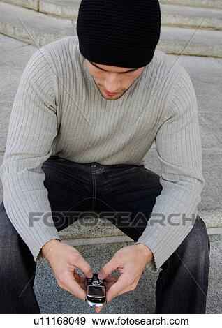 Portrait of a young man with his cell phone. View Large Photo Image Stock Photo - Portrait of a young man with his cell phone.. Fotosearch