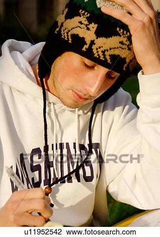 Portrait of a young man writing in a book. View Large Photo Image Stock Image - Portrait of a young man writing in a book.. Fotosearch