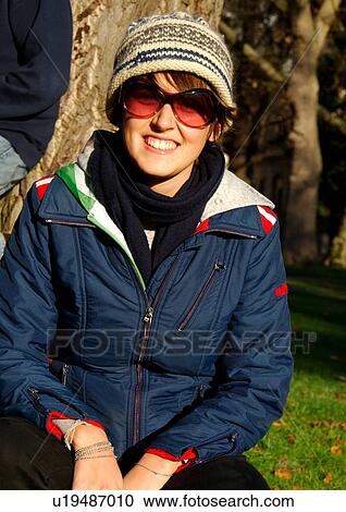 Portrait of a young woman wearing sunglasses. View Large Photo Image Stock Image - Portrait of a young woman wearing sunglasses.. Fotosearch