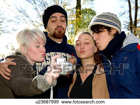 Portrait of four people recording themselves on a camcorder. View Large Photo Image Stock Photo - Portrait of four people recording themselves on a camcorder.. Fotosearch