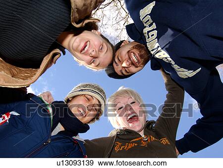 Stock Photo - Portrait of four people smiling at the camera.. Fotosearch