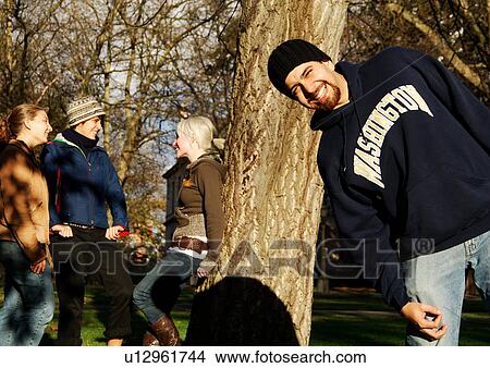 View of a man playfully smiling at the camera. View Large Photo Image Picture - View of a man playfully smiling at the camera.. Fotosearch
