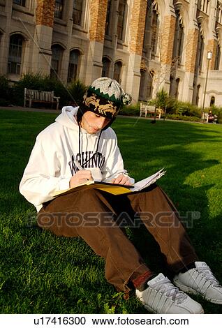 View of a young man engrossed in a book. View Large Photo Image Stock Image - View of a young man engrossed in a book.. Fotosearch