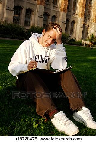 View of a young man engrossed in a book. View Large Photo Image Stock Photography - View of a young man engrossed in a book.. Fotosearch