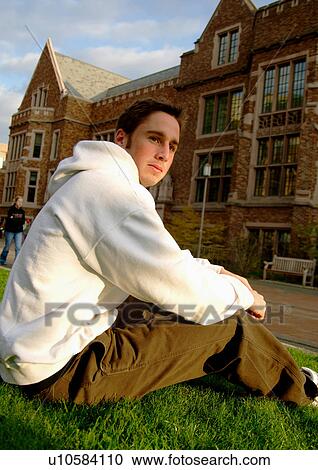 View of a young man relaxing on a lawn. View Large Photo Image Stock Image - View of a young man relaxing on a lawn.. Fotosearch