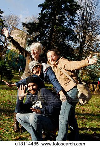 View of four friends posing for the camera. View Large Photo Image Stock Photography - View of four friends posing for the camera.. Fotosearch