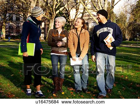 Picture - View of four friends spending time together.. Fotosearch
