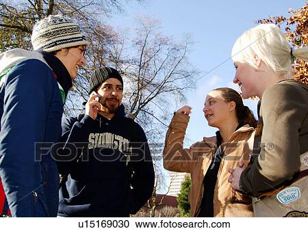 Stock Image - View of four friends spending time together.. Fotosearch