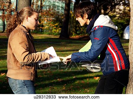View of two young women engrossed in a discussion. View Large Photo Image Stock Image - View of two young women engrossed in a discussion.. Fotosearch