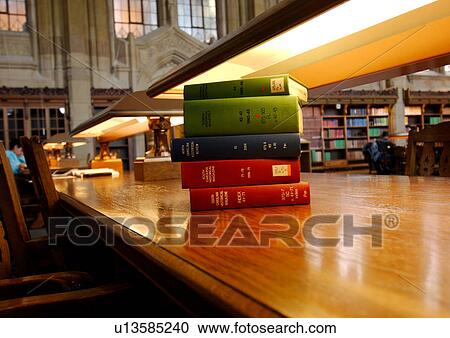 Close-up of a stack of books under a reading lamp. View Large Photo Image Stock Image - Close-up of a stack of books under a reading lamp.. Fotosearch