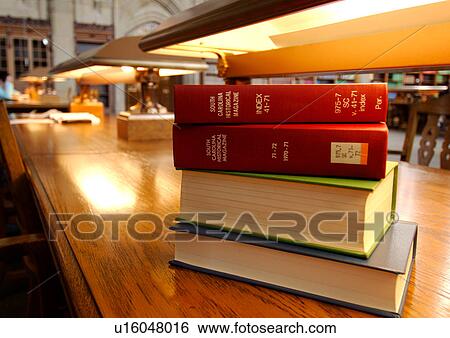 Close-up of a stack of books under a reading lamp. View Large Photo Image Stock Photograph - Close-up of a stack of books under a reading lamp.. Fotosearch