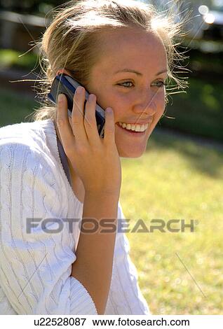 Close-up of a woman conversing on a cell phone. View Large Photo Image Stock Photo - Close-up of a woman conversing on a cell phone.. Fotosearch