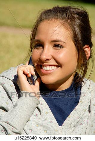 Close up of a young woman talking on her cell phone. View Large Photo Image Stock Image - Close up of a young woman talking on her cell phone.. Fotosearch