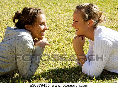 Stock Photography - Portrait of two young women face to face.. Fotosearch