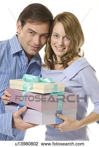 A couple holds boxes of gifts. View Large Photo Image Stock Image - A couple holds boxes of gifts.. Fotosearch
