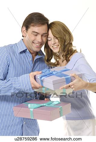 A couple holds boxes of gifts. View Large Photo Image Stock Photograph - A couple holds boxes of gifts.. Fotosearch