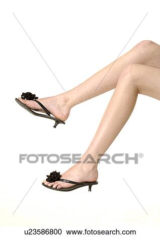 Stock Image - Cropped view of a woman wearing stylish footwear.. Fotosearch