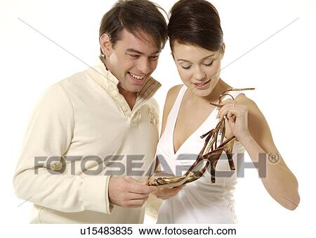 Front view of a couple looking at their purchase. View Large Photo Image Stock Photography - Front view of a couple looking at their purchase.. Fotosearch