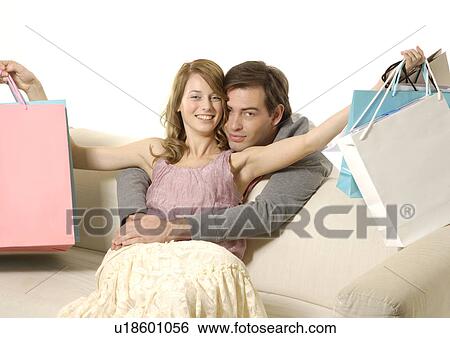 Front view of a couple with their purchase. View Large Photo Image Stock Photograph - Front view of a couple with their purchase.. Fotosearch