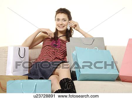 Front view of a young woman talking on her cellphone. View Large Photo Image Stock Image - Front view of a young woman talking on her cellphone.. Fotosearch
