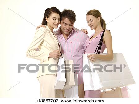 Front view of young shoppers posing with their carrier bags. View Large Photo Image Stock Image - Front view of young shoppers posing with their carrier bags.. Fotosearch