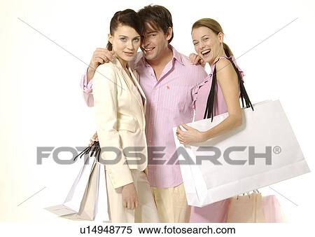Front view of young shoppers posing with their carrier bags. View Large Photo Image Stock Photography - Front view of young shoppers posing with their carrier bags.. Fotosearch