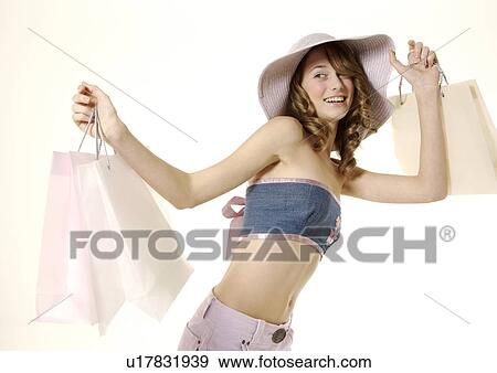 Portrait of a fashionable woman holding her carrier bags. View Large Photo Image Stock Photo - Portrait of a fashionable woman holding her carrier bags.. Fotosearch