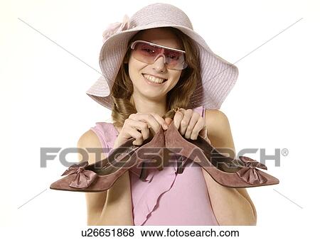 Portrait of a fashionable woman holding a pair of shoe. View Large Photo Image Stock Photo - Portrait of a fashionable woman holding a pair of shoe.. Fotosearch