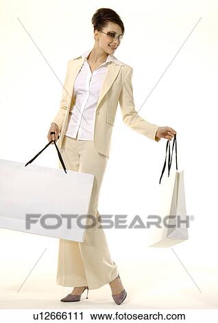 Portrait of a fashionable woman posing with shopping bags. View Large Photo Image Stock Image - Portrait of a fashionable woman posing with shopping bags.. Fotosearch