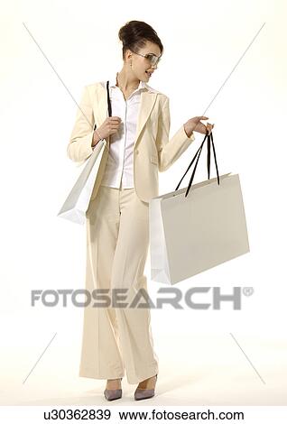 Portrait of a fashionable woman posing with shopping bags. View Large Photo Image Stock Photo - Portrait of a fashionable woman posing with shopping bags.. Fotosearch