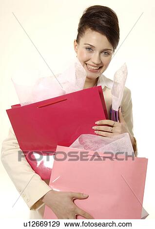 Portrait of a trendy young woman carrying shopping bags. View Large Photo Image Stock Photo - Portrait of a trendy young woman carrying shopping bags.. Fotosearch