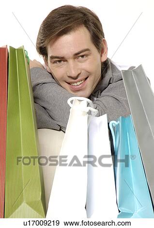 Portrait of a young man with his shopping bags. View Large Photo Image Stock Photo - Portrait of a young man with his shopping bags.. Fotosearch