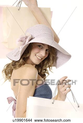Portrait of a young woman carrying her shopping bags. View Large Photo Image Picture - Portrait of a young woman carrying her shopping bags.. Fotosearch