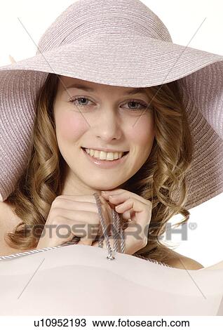 Stock Image - Portrait of a young woman carrying her shopping bag.. Fotosearch