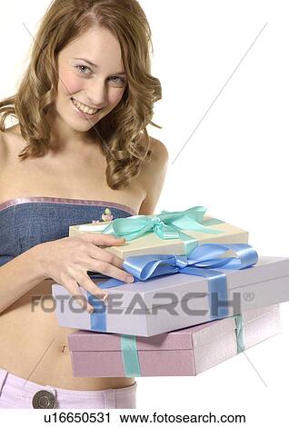 Portrait of a young woman carrying boxes of gifts. View Large Photo Image Stock Image - Portrait of a young woman carrying boxes of gifts.. Fotosearch