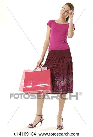 Portrait of a young woman in thought about her shopping. View Large Photo Image Picture - Portrait of a young woman in thought about her shopping.. Fotosearch