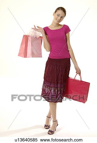 Stock Photography - Portrait of a young woman posing with her shopping bags.. Fotosearch