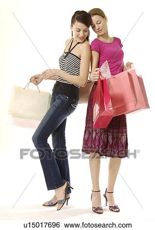 Portrait of two young women on a shopping spree. View Large Photo Image Stock Photograph - Portrait of two young women on a shopping spree.. Fotosearch