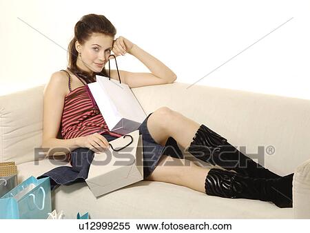 Side view of a women sitting on a couch. View Large Photo Image Stock Photography - Side view of a women sitting on a couch.. Fotosearch