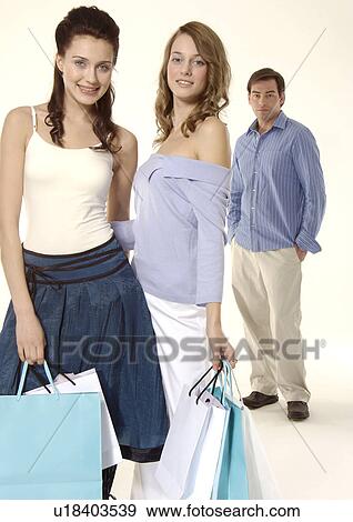 Stock Photo - Three people are posing for the camera.. Fotosearch