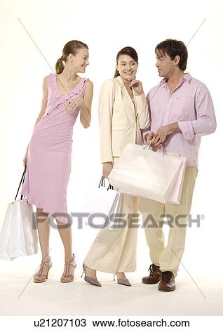 Three people are posing with their shopping bags. View Large Photo Image Stock Image - Three people are posing with their shopping bags.. Fotosearch