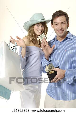 View of a couple with their shopping bags. View Large Photo Image Stock Image - View of a couple with their shopping bags.. Fotosearch