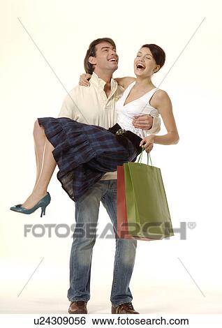 View of a man carrying his partner. View Large Photo Image Stock Photograph - View of a man carrying his partner.. Fotosearch