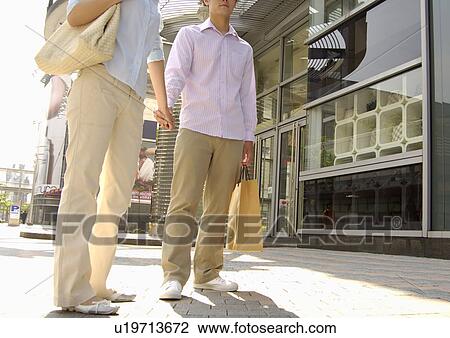 Cropped view of a couple shopping together. View Large Photo Image Stock Image - Cropped view of a couple shopping together.. Fotosearch